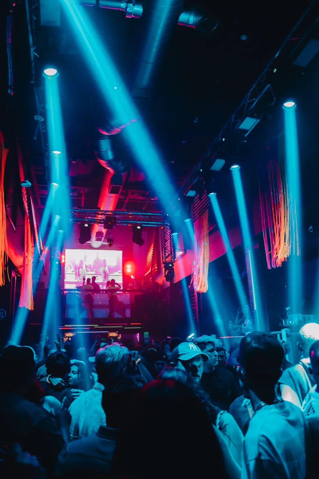Packed room under blue light beams