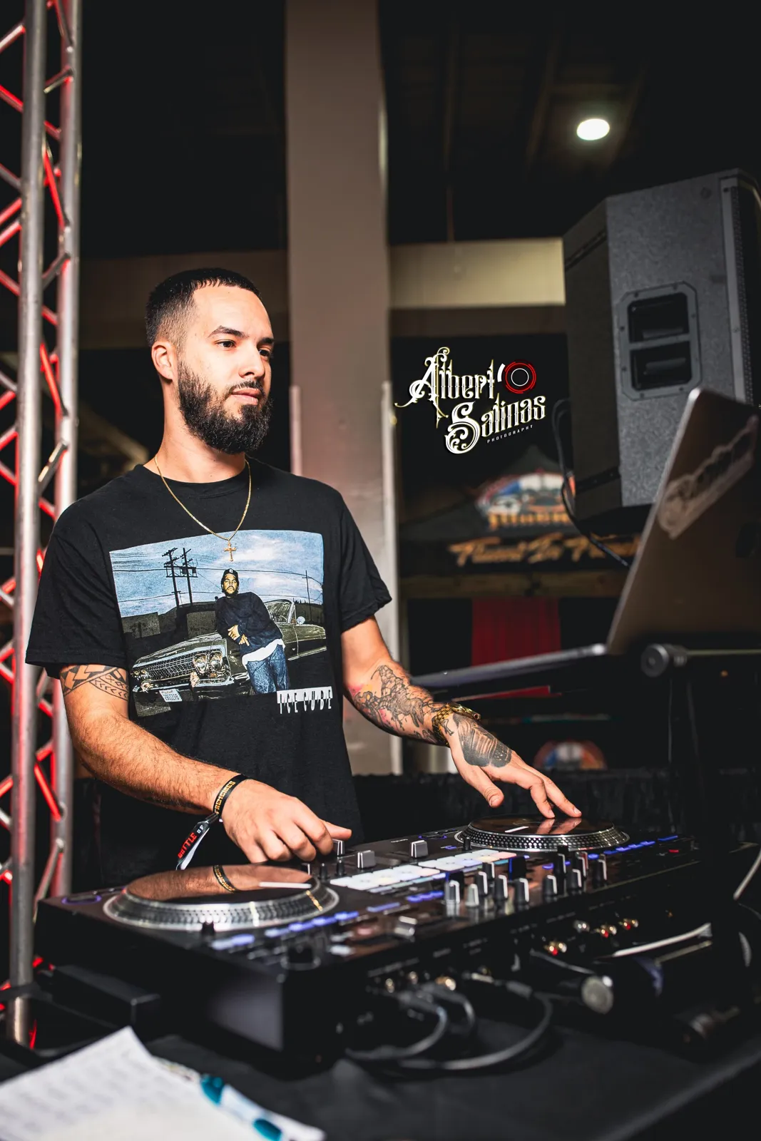 DJ Tury mixing under the truss lights