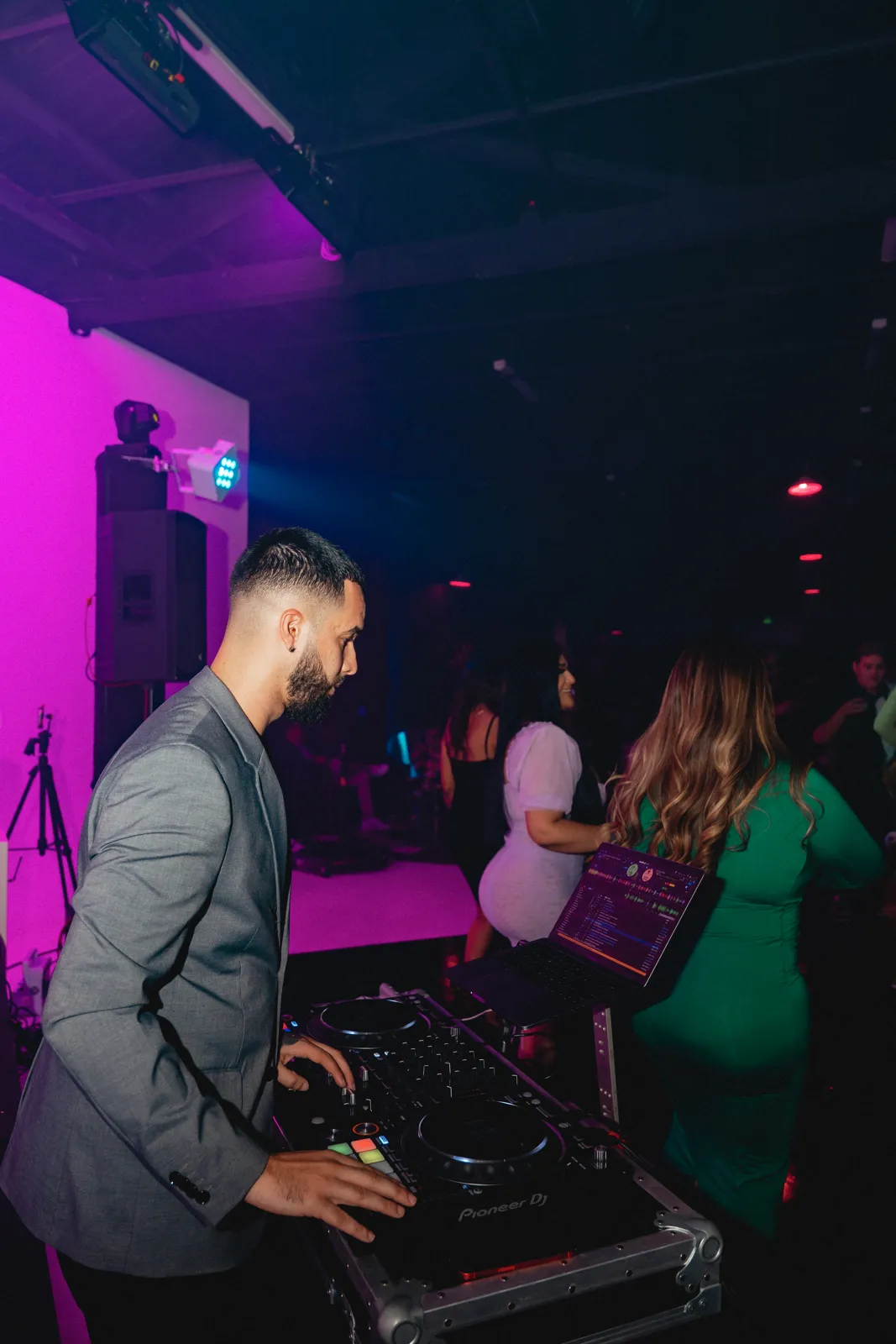 DJ Tury in a pink-lit lounge