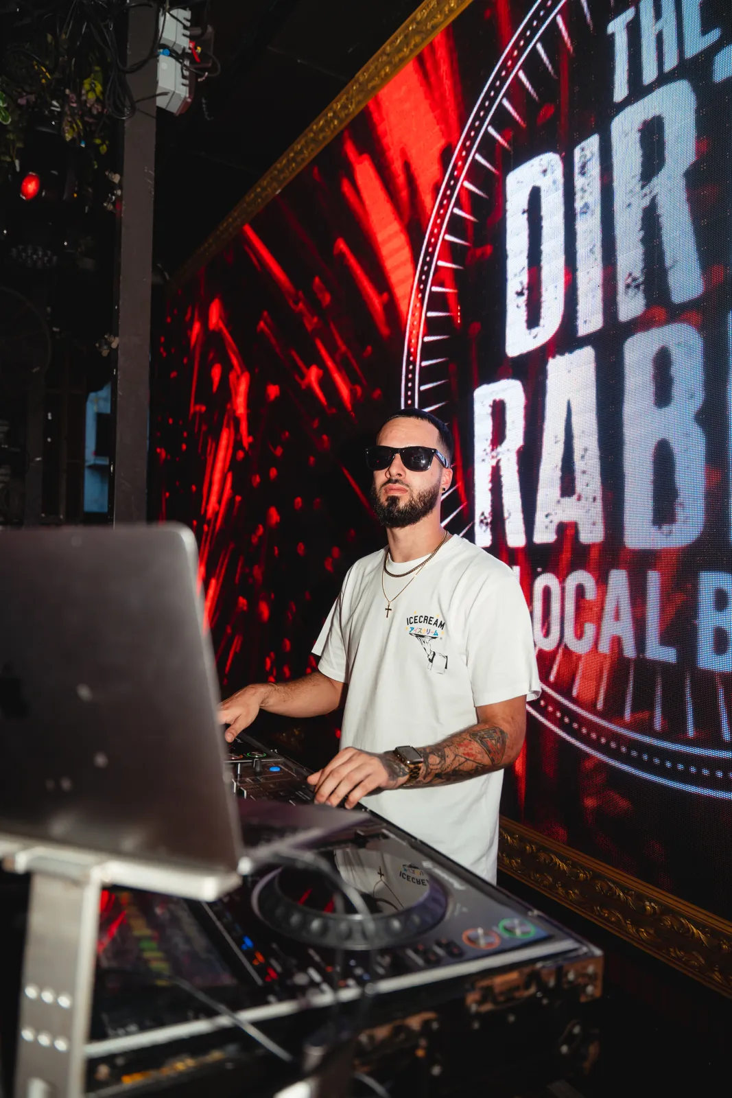 DJ Tury under The Dirty Rabbit neon