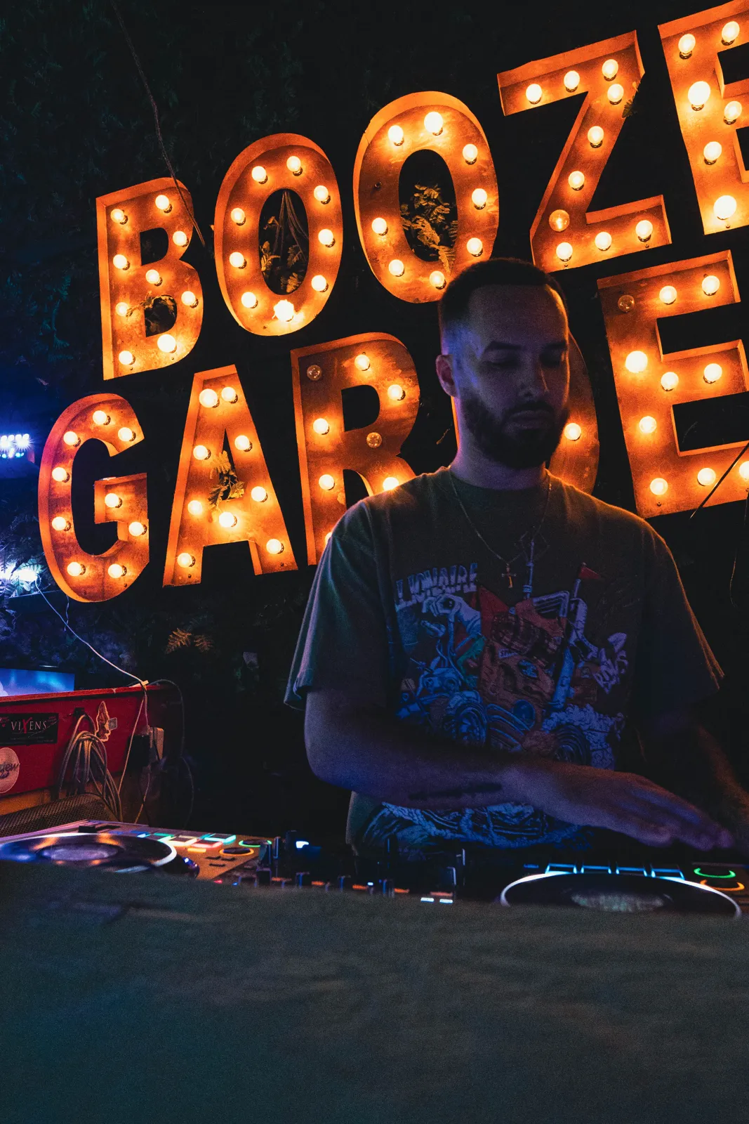 DJ Tury in front of the Booze Garden marquee